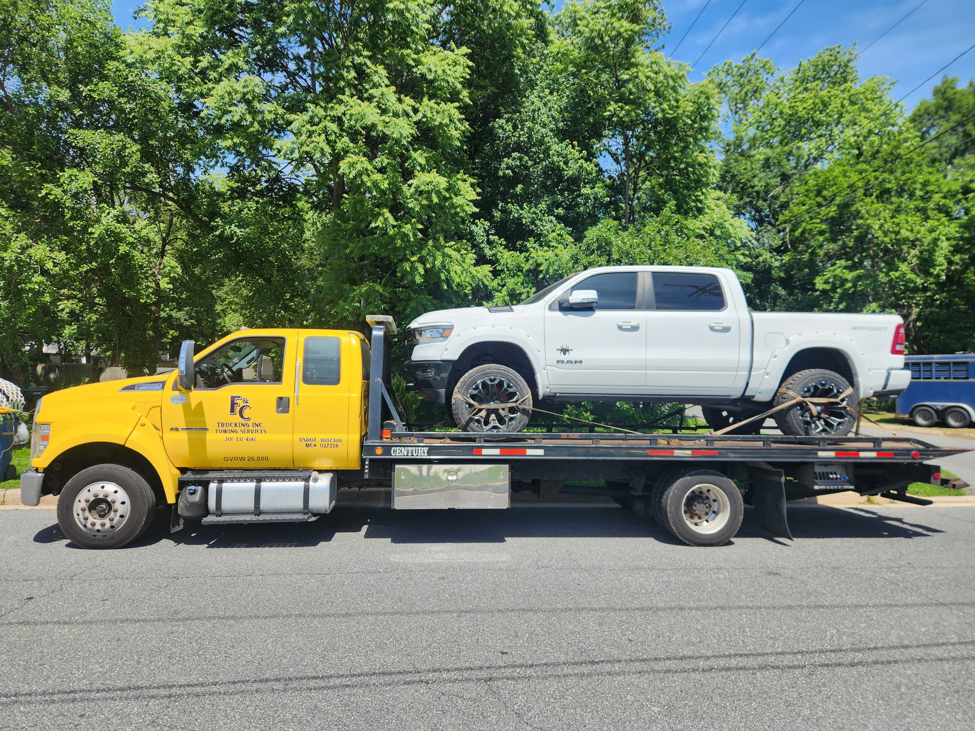 F&C Trucking Inc yellow flatbed tow truck in Laurel MD